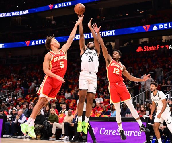 o<em></em>nyeka Okongwu, who scored xx points, blocks Dorian Finney-Smith's shot during the Nets' 120-116 opening-night loss to the Hawks on Oct. 23, 2024.