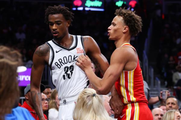 Dyson Daniels #5 of the Atlanta Hawks reacts towards Nic Claxton #33 of the Brooklyn Nets during the fourth quarter at State Farm Arena on October 23, 2024 in Atlanta, Georgia. 