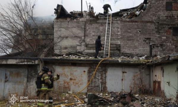 Ukrainian rescue workers put out a fire at a building which was heavily damaged by the Russian strike on Dnipro, 21 November 2024.