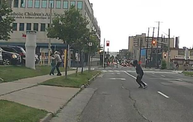 A screenshot from dashcam footage released by Hamilton police shows a shooting in broad daylight in August, with one person using another as a human shield.