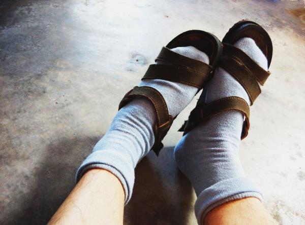 Wearing socks with sandal.