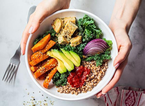 Baked vegetables, avocado, tofu and buckwheat buddha bowl