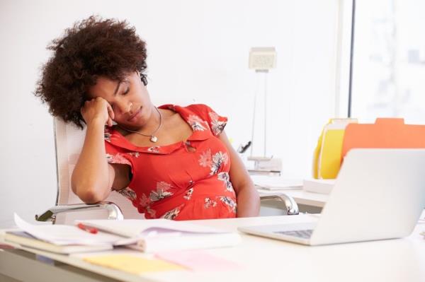 Tired woman sleeping at her desk