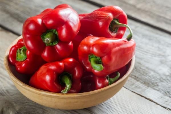 Red Bell Peppers in a wood bowl