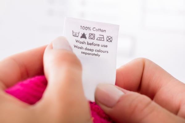 Woman Looking at a Clothing Label