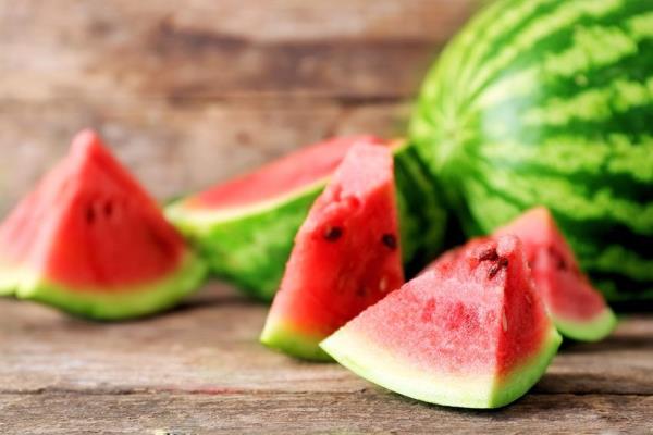 Pieces of cut watermelon on wooden surface