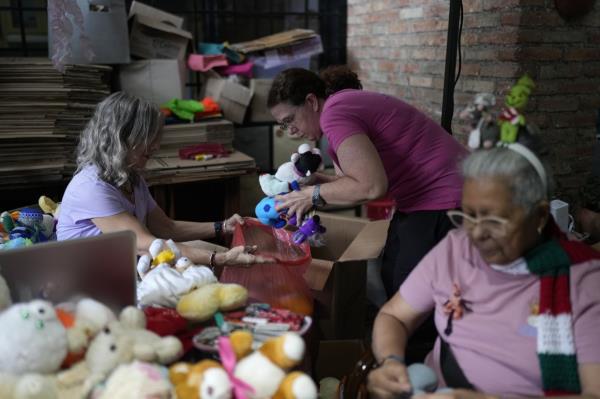 Volunteers recycle and restore used toys to do<em></em>nate them to children.