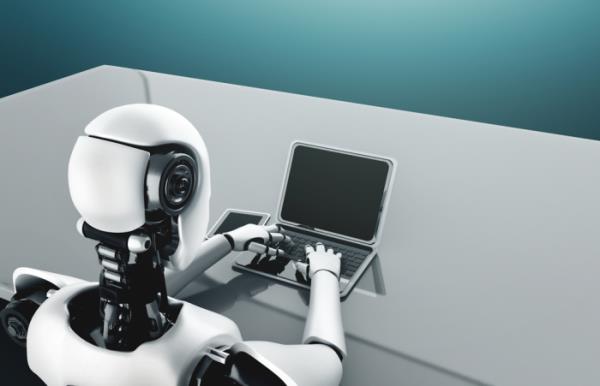 A　robot　humanoid　backed　by　an　AI-thinking　brain　uses　a　laptop　(Courtesy　of　Getty　Images)