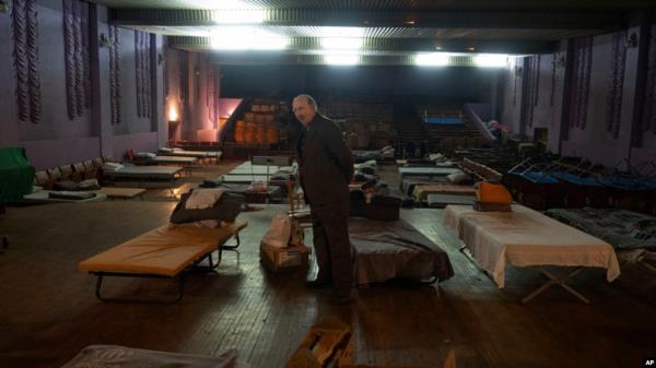 A man waits for evacuation to western Ukraine as he stands by a bed in a city theater that hosts refugees running from Russian offensive in the Do<em></em>netsk region, in Pavlohrad, Dnipropetrovsk region, Ukraine, Dec. 12, 2024.