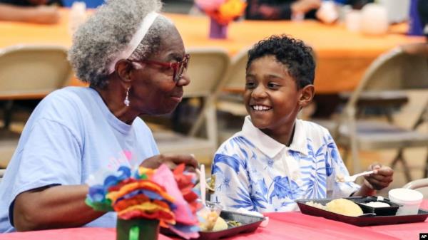 FILE - Third grader Dallin Curry, 8, talks with his grandmother Mary Durr on Sept. 6, 2024, during a Grandparents Day celebration in the lunchroom at Burns Elementary School in Owensboro, Ky. 