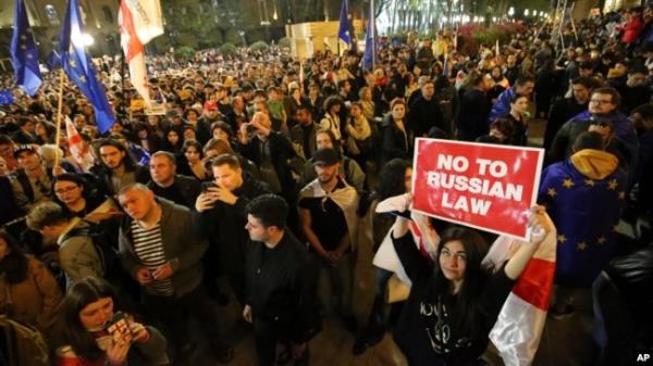 FILE - Protesters gather outside the parliament building in Tbilisi, Georgia, on April 15, 2024, to protest the 