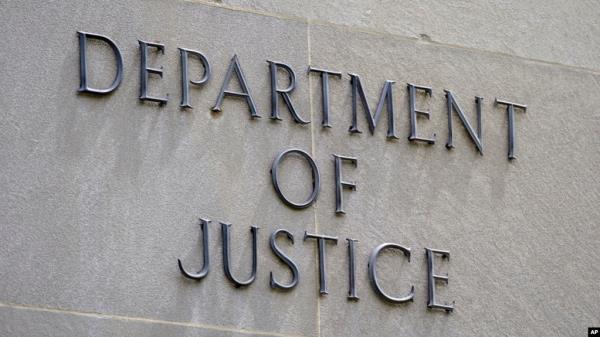 FILE - Signage is seen outside of the Department of Justice building in Washington. 