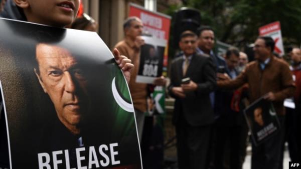FILE - A supporter of Pakistan Tehreek-e-Insaf (PTI) party and jailed former prime minister Imran Khan holds a placard during a protest rally in Sydney on Aug. 4, 2024, demanding Khan's release from the jail.