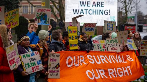 Activists protest outside the Internatio<em></em>nal Court of Justice, in The Hague, Netherlands, as it opens hearings into what countries worldwide are legally required to do to combat climate change and help vulnerable nations fight its impact, Dec. 2, 2024. 