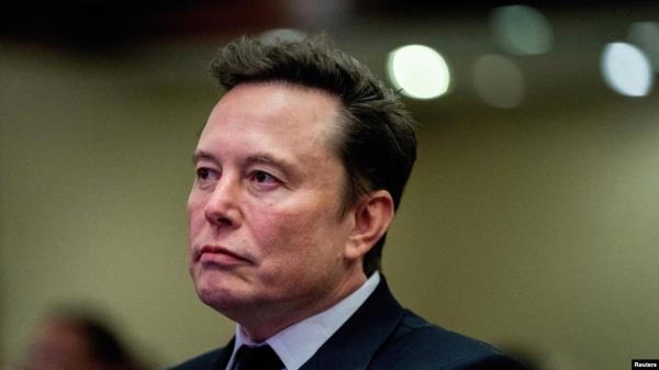 FILE - Tesla CEO and X owner Elon Musk listens as US President-elect Do<em></em>nald Trump speaks during a meeting with House Republicans at the Hyatt Regency hotel in Washington, on November 13, 2024. 