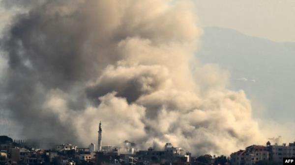 Thick smoke rises from explosions as Israeli forces reportedly demolish dwellings in the border town of Khiam in southern Lebanon, on Dec. 1, 2024, days into a fragile ceasefire between Israel and Hezbollah.