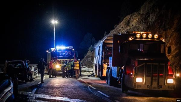Police officers and rescuers work the scene of a bus accident in Porte-Puymorens, southern France, Dec. 1, 2024.