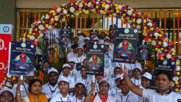 FILE - Indian health workers, volunteers and students take out a health awareness procession to mark the World AIDS Day in Hyderabad, India, Dec. 1, 2022.