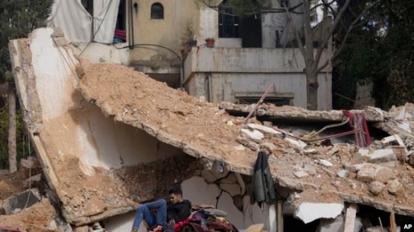 A man sits on the rubble of a destroyed house in Baalbek, eastern Lebanon, Nov. 28, 2024.