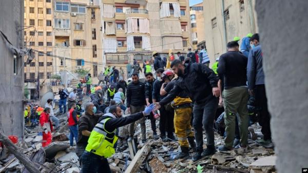 Rescuers search for victims at the site of an Israeli airstrike that targeted a building in Beirut, Lebanon, Nov. 26, 2024. 
