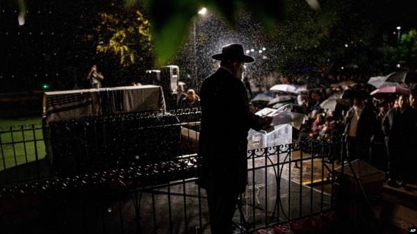 A rabbi delivers a eulogy next to the coffin co<em></em>ntaining the remains of Israeli-Moldovan rabbi Zvi Kogan in Kfar Chabad, Israel, Nov. 25, 2024. Kogan, 28, an ultra-Orthodox rabbi, was killed last week in Dubai wher<em></em>e he ran a kosher grocery store. 