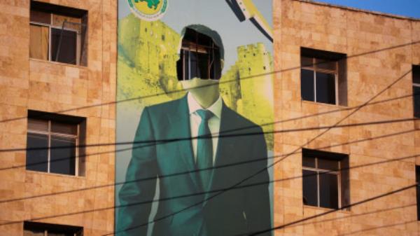 A view shows a damaged poster of Syria's President Bashar al-Assad in Aleppo, after the Syrian army said that dozens of its soldiers had been killed in a major attack by rebels who swept into the city, in Syria November 30, 2024. REUTERS/Mahmoud Hassano