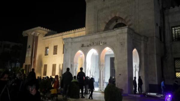 People gather in front of Hama governor's building after Syrian rebels captured the city during their advance across northern Syria, in Hama, Syria December 5, 2024. REUTERS