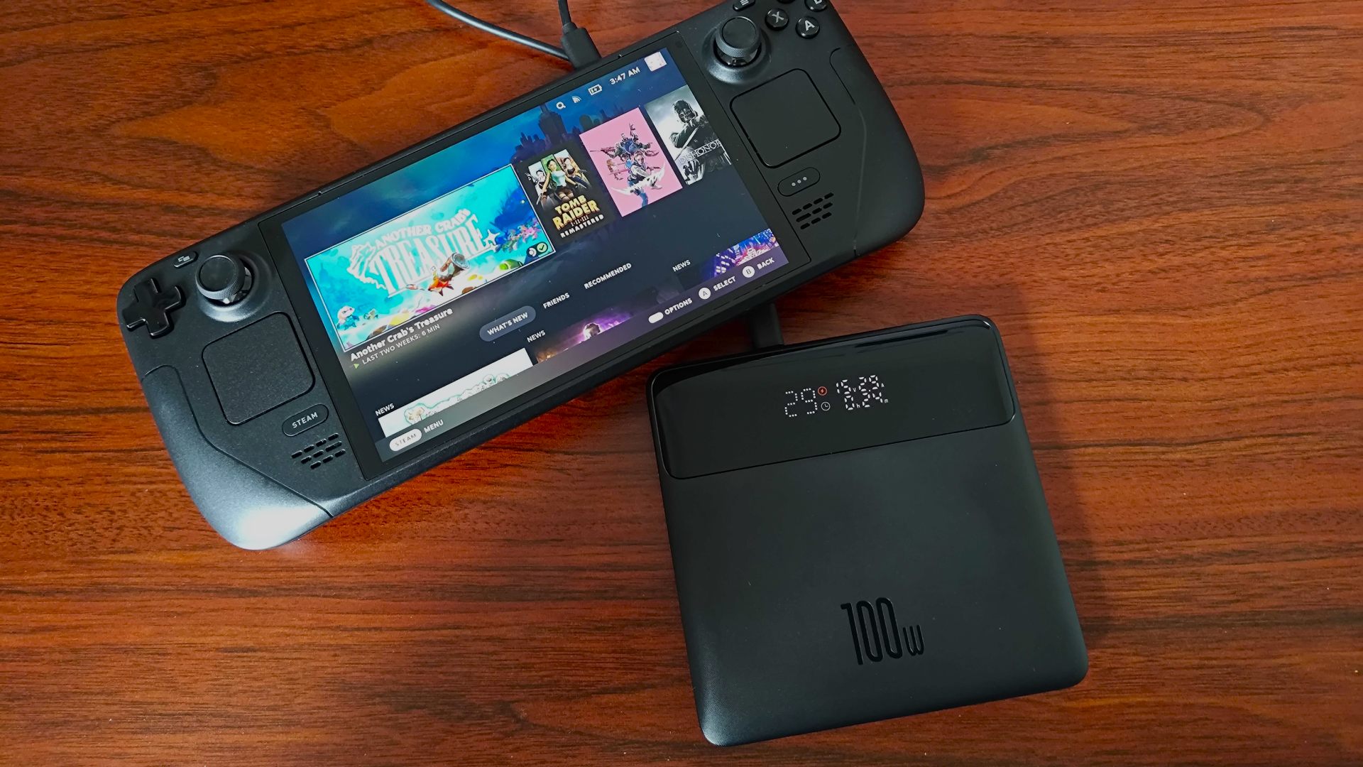 ba<em></em>seus Blade power bank next to Steam Deck OLED