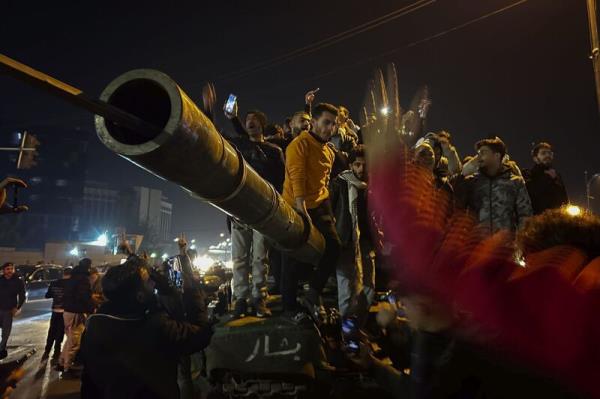 Syrians celebrate the arrival of opposition fighters in Damascus, Syria, Sunday Dec. 8, 2024. Picture: AP Photo/Omar Sanadiki