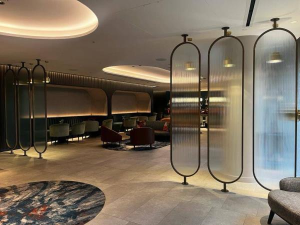 Glass room dividers create zo<em></em>nes and provide some privacy without blocking light.