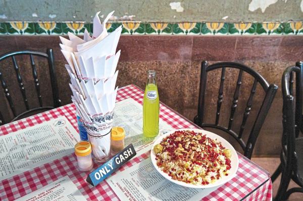 Paneer Berry Pulav and a bottle of Pallonji’s neon-yellow ginger soda at the cash-o<em></em>nly Britannia & Co.