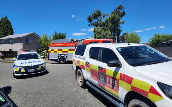 Two police cars and two fire trucks are at the scene of a house fire in the Christchurch suburb of Hornby.