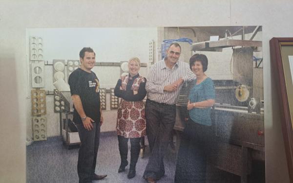 An old photo of Grant and Karen with two workers at the Maketū Pies factory.