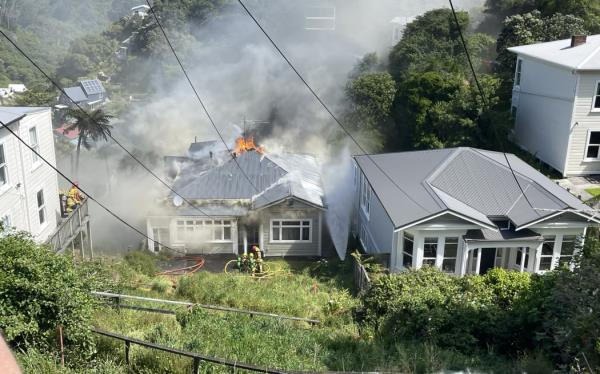 Firefighters working on a house fire in Kelburn.