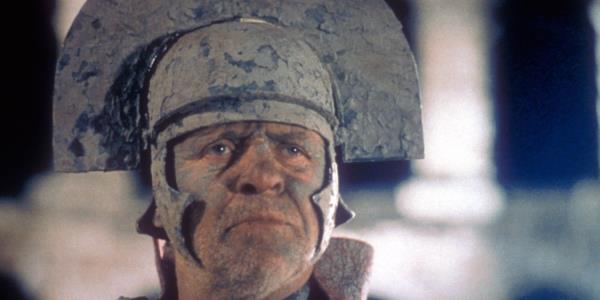 Anthony Hopkins as Titus Andro<em></em>nicus covered in mud and wearing a helmet in Titus 1999