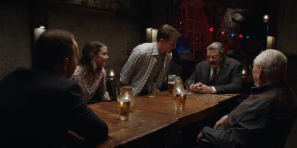 Jamie sitting down at the table while The Reagans have dinner at a restaurant in Blue Bloods