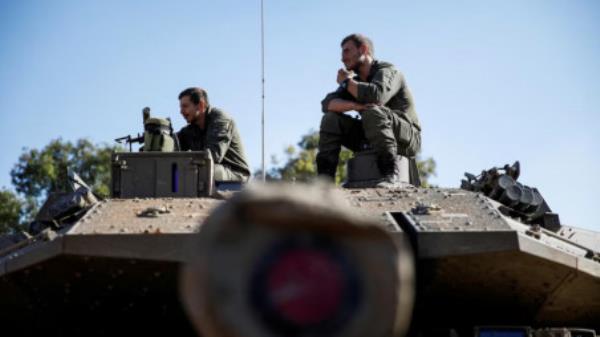 Israeli soldiers sit on a military vehicle near Israel's border with Lebanon, following the ceasefire between Israel and Iran-backed group Hezbollah, in northern Israel, December 5, 2024. Photo: REUTERS/Shir Torem/File Photo