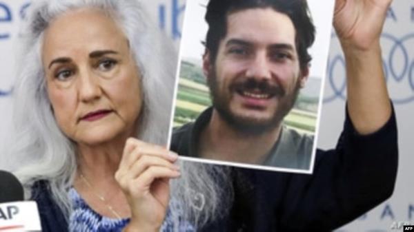 FILE - Debra Tice, mother of U.S. journalist Austin Tice, holds a portrait of her son during a press co<em></em>nference in Beirut, Lebanon, July 20, 2017. Tice has been held in Syria since 2012. On Dec. 24, 2024, Hostage Aid Worldwide said it believes Tice is still alive. 