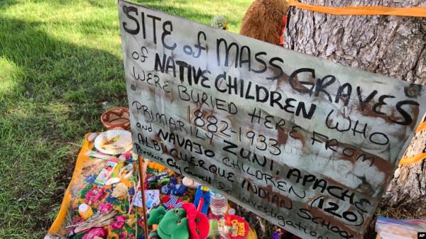 FILE - A makeshift memorial for the dozens of Indigenous children who died more than a century ago while attending a boarding school that was o<em></em>nce located nearby is growing under a tree at a public park in Albuquerque, New Mexico, July 1, 2021. 