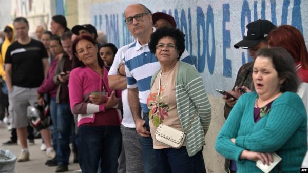 FILE - People line up to vote during the municipal elections runoff in Sao Paulo on Oct. 27, 2024. In Brazil's polarized election environment, women and minority journalists faced a disproportio<em></em>nate number of o<em></em>nline and offline attacks.