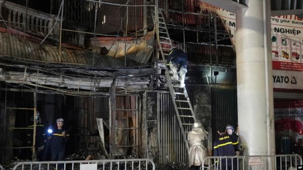Fire perso<em></em>nnel inspect a building burned down by a fire in Hanoi, Vietnam, Dec.19, 2024.