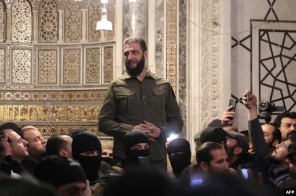 Islamist group Hayat Tahrir al-Sham (HTS) leader Abu Mohammed al-Jolani addresses a crowd at the capital's landmark Umayyad Mosque in Damascus, Syria, Dec. 8, 2024.