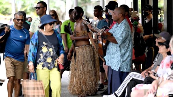 FILE - Traditio<em></em>nal dancers perform to attract tourists at a shopping mall in downtown Suva, Fiji, on Dec. 15, 2022.