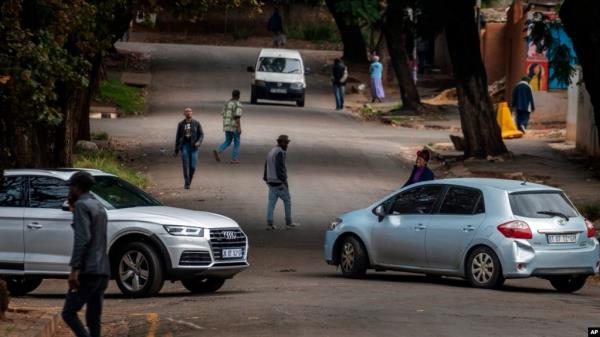 FILE - Few cars and residents are seen in the normally busy streets of Yeoville, downtown Johannesburg, South Africa, April 10, 2020. 