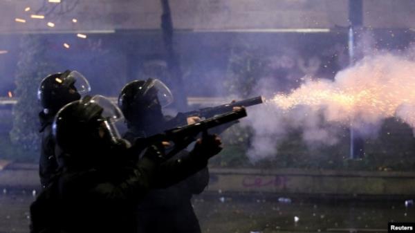 FILE - Law enforcement officers fire tear gas canisters as fireworks explode during a protest against the new government's decision to suspend the European Unio<em></em>n accession talks and refuse budgetary grants until 2028, in Tbilisi, Dec. 2, 2024.