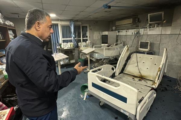 Hussam Abu Safiya, director of Kamal Adwan Hospital, shows the damage inside the hospital