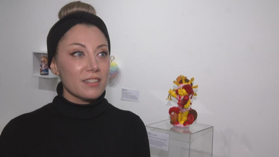 Sculptor Andy Fischer stands with a bad gift she donated: A cabbage patch doll that was given to her by an admirer who decided to re-decorate it with some pretty eerie parts.