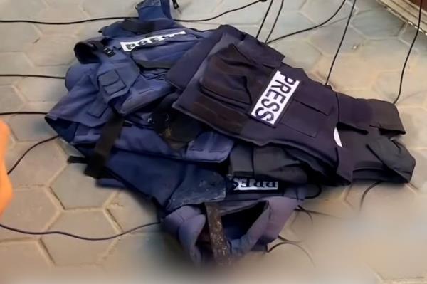 Press vests on the ground as Palestinian Journalists in Gaza protest the targeting of press and Al Jazeera colleagues.