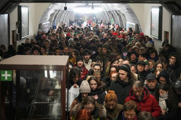 People take shelter in a metro station during an air raid alarm in Kyiv