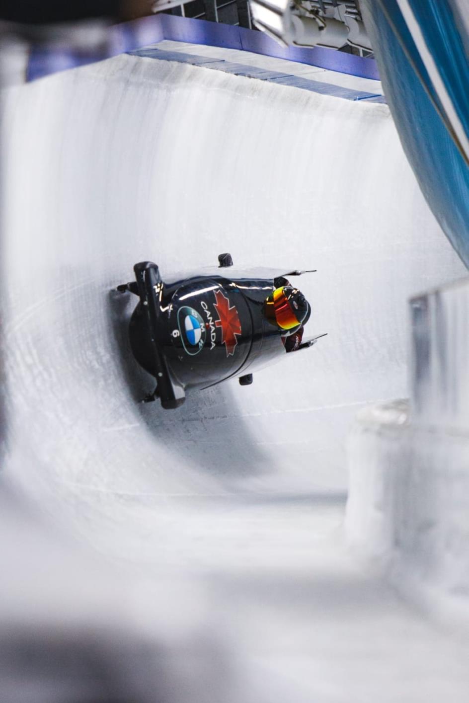 A bobsled plummeting down the icy path. 